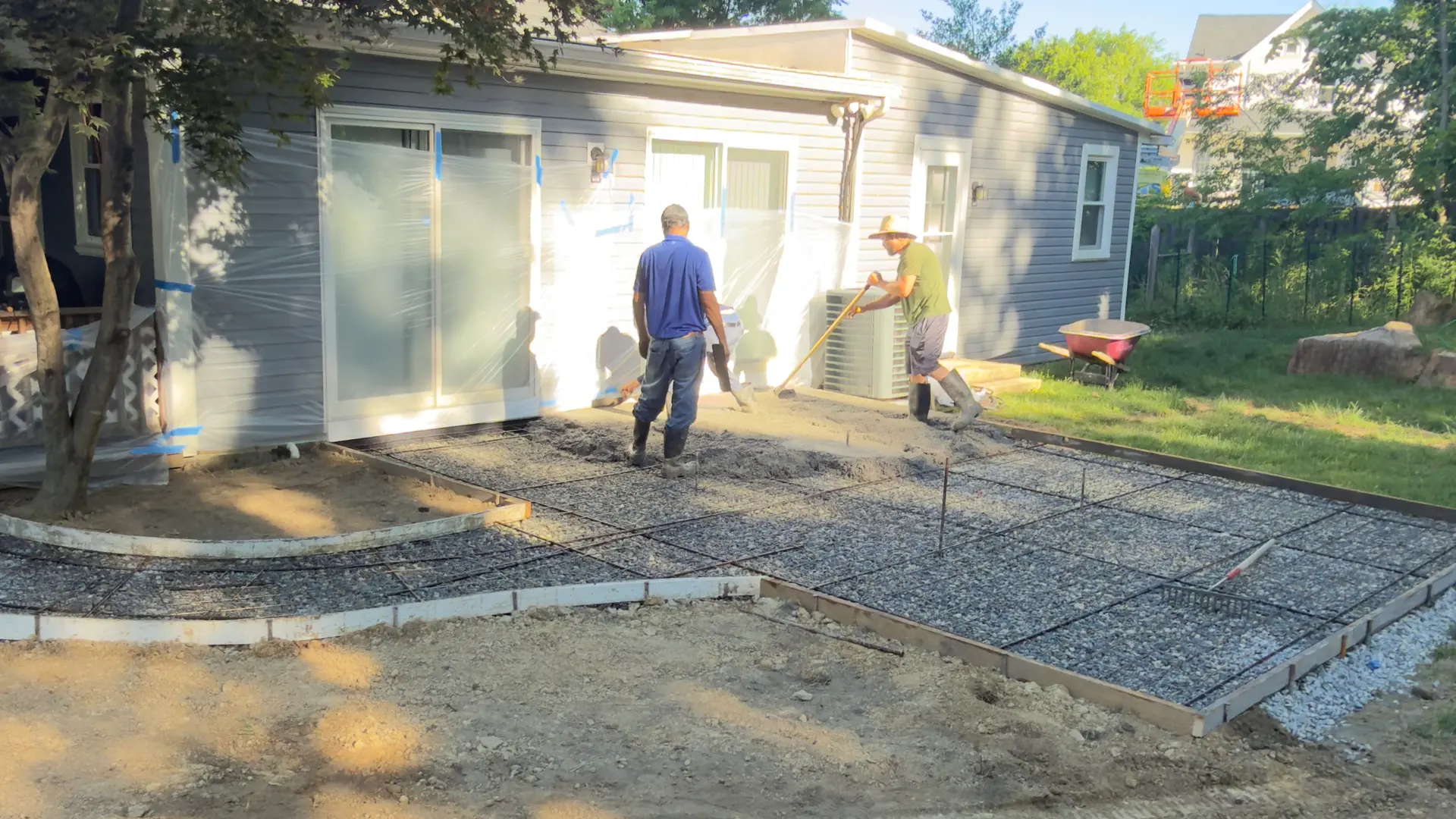 A Blue Rock crew setting forms and wire mesh over a gravel base before a pour